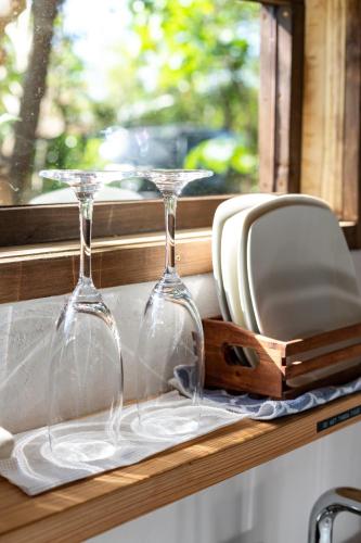two wine glasses sitting on a window sill at Tree-house Hotel Morinosubako in Nakijin