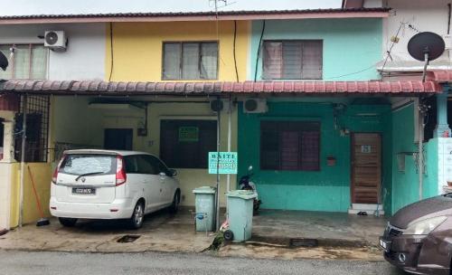 a white car parked in front of a house at Bajet Homestay - low cost houses in Kuantan