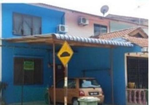 a blue house with a car parked in front of it at Bajet Homestay - low cost houses in Kuantan