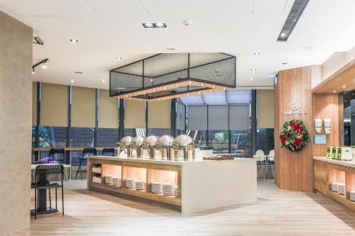 a restaurant lobby with a counter and a chandelier at Palmer Hotel in Taichung