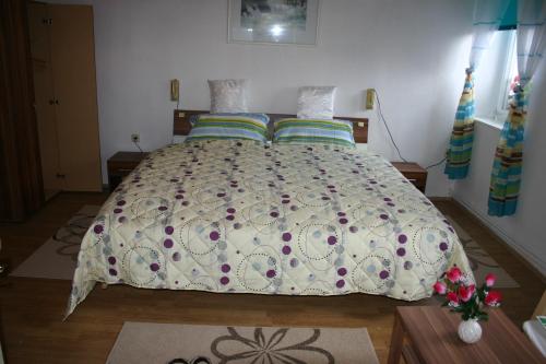 a bedroom with a large bed with a comforter and pillows at Hotel "Alte Schule" Trogen in Trogen