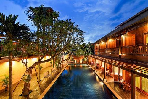 a swimming pool in the middle of a building at Baan U Sabai Boutique House-SHA Plus in Chiang Mai