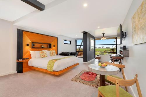 a bedroom with a bed and a living room at Hotel California Road at Inkwell Wines in McLaren Vale