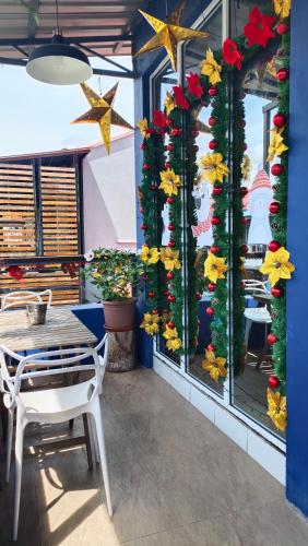 a restaurant with a table and a window with christmas decorations at Kuree Hut in Semporna
