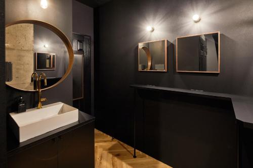 a bathroom with a sink and a mirror at ZONK HOTEL Nakasu-Deaibashi in Fukuoka