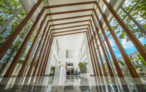 a view of the lobby of a building with wooden beams at Ocean V Hotel in Pereybere