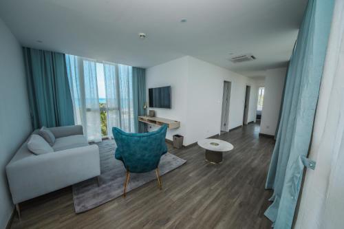 a living room with a couch and a chair at Ocean V Hotel in Pereybere