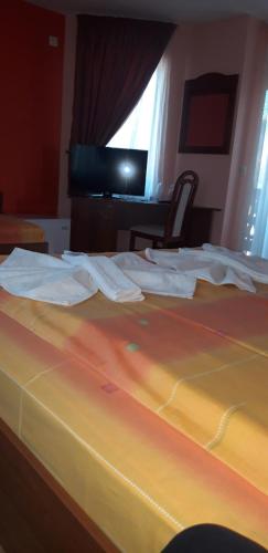 a bed with some towels on top of it at Guest House H Dzhogolanov in Koprivshtitsa