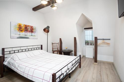 a bedroom with a bed and a ceiling fan at House 54 in Braşov