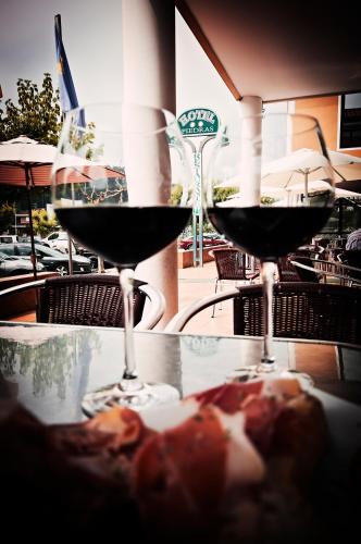 two glasses of red wine sitting on a table at Hotel Piedras in Piedras Blancas