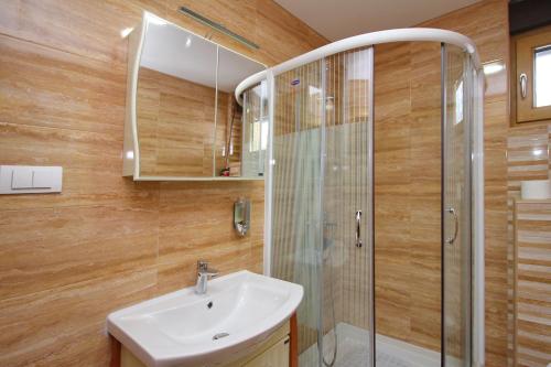 a bathroom with a sink and a shower at Apartment Jony Lux Center in Zlatibor