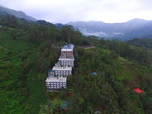 an overhead view of a building on a hill at Chandys Windy Woods Munnar in Munnar