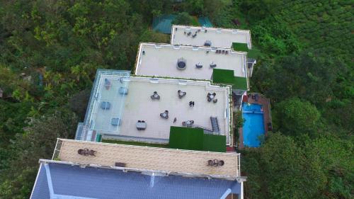 an overhead view of a building with people on it at Chandys Windy Woods Munnar in Munnar