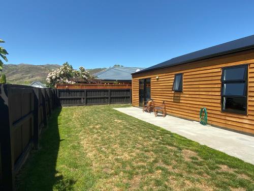 a backyard of a house with a fence at Central Retreat and self contained with free wifi in Cromwell