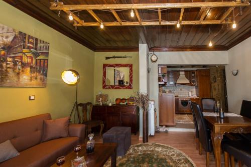a living room with a couch and a table at Petra Thea Villa Karitaina in Karítaina