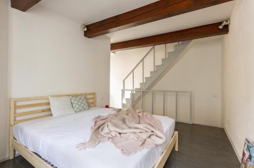 a bedroom with a bed and a staircase at Cedro Apartment - Smart Holiday in Mantova