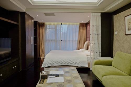 a hotel room with a bed and a couch at Ring Service Apartment 798 Art Zone in Beijing