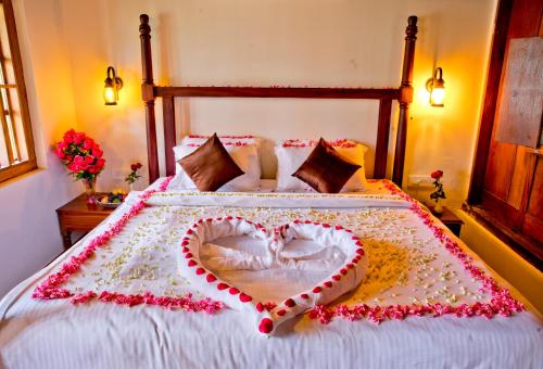 a bed with two hearts painted on it at Wild Saga in Thekkady