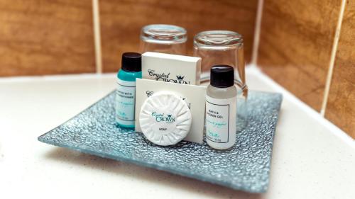 a shelf with two bottles of soap and a box at Crystal Crown Hotel Kuala Lumpur in Kuala Lumpur