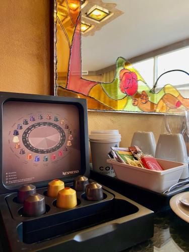 a kitchen counter with a stove top with a microwave at Art 'Otel in Sofia
