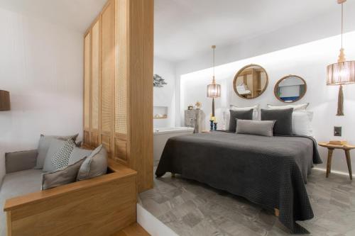 a bedroom with a bed and a mirror at Athina Studios and Suites Plaka in Plaka