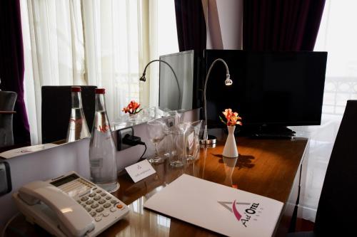 a desk with a computer and a telephone on it at Art 'Otel in Sofia