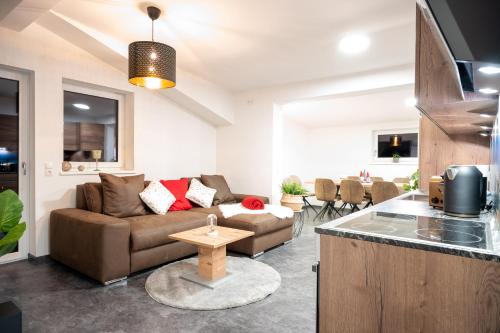 a living room with a couch and a table at Amelies Mountain View in Kaprun