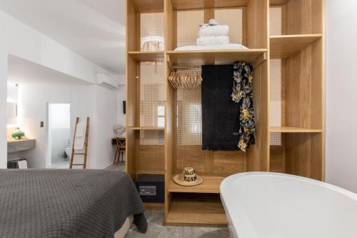 a room with a bedroom with a bed and a shelf at Athina Studios and Suites Plaka in Plaka