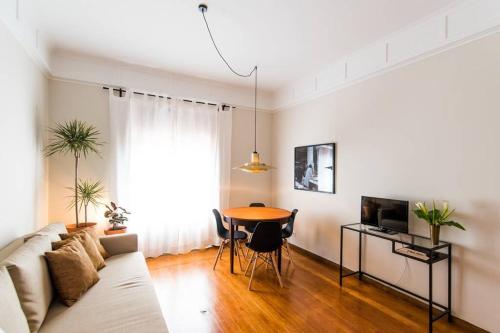 a living room with a couch and a table at GuestReady - Rivoli Studio in Porto