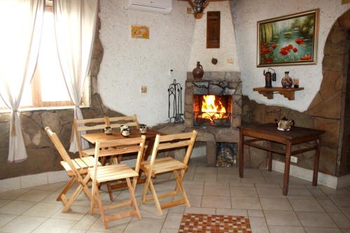 a dining room with a table and a fireplace at Inn Khlibodarskiy in Khlibodarske