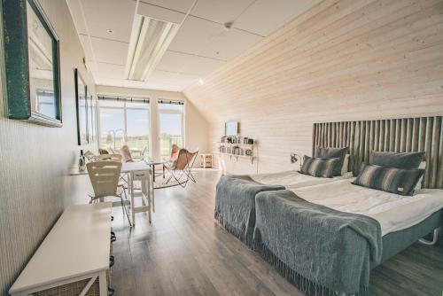 Schlafzimmer mit einem Bett, einem Tisch und Stühlen in der Unterkunft Halmstad Golfarena Hotell & Lägenheter in Halmstad