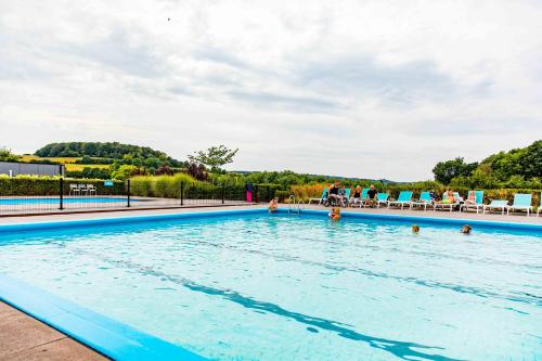 a large swimming pool with people in the water at TopParken – Résidence Valkenburg in Valkenburg