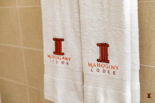 a white towel in a bathroom with the monbury house at Mahogany Lodge, Cantonments in Accra