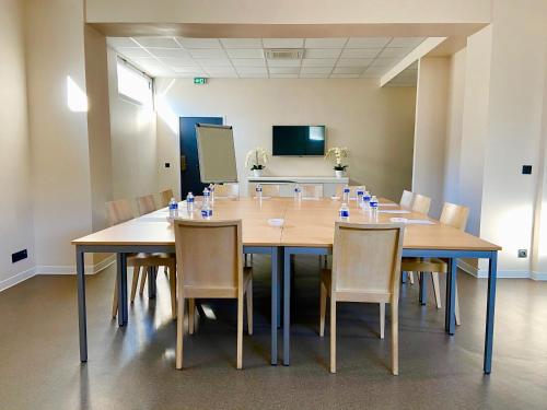 a conference room with a large wooden table and chairs at Best Western Hôtel Journel Antibes Juan-les-Pins in Antibes