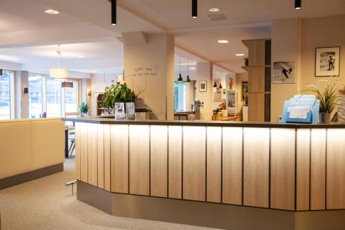 a lobby with a large counter in a store at JUFA Hotel Kaprun - Summercard included in Kaprun