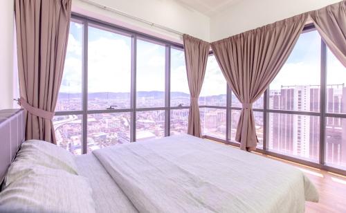 a bedroom with a bed and large windows at Rex Ollie @ The Elements Ampang in Kuala Lumpur