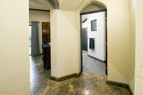 an empty room with a hallway with a door in it at Stephan's Guest House in Port Shepstone