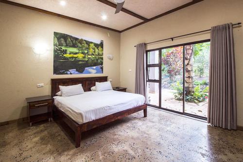 a bedroom with a bed and a large window at Stephan's Guest House in Port Shepstone