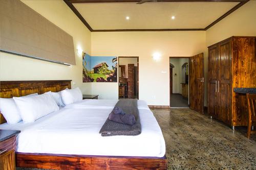 a bedroom with a large white bed in a room at Stephan's Guest House in Port Shepstone