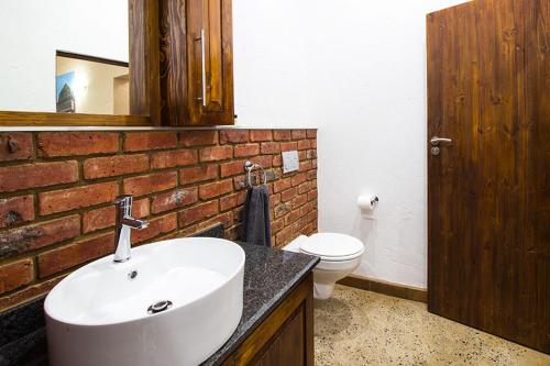 a bathroom with a white sink and a toilet at Stephan's Guest House in Port Shepstone