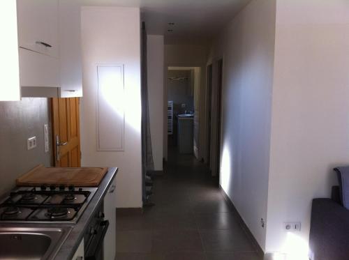 a kitchen with a stove and a long hallway at Domaine Casa Andria in Barbaggio