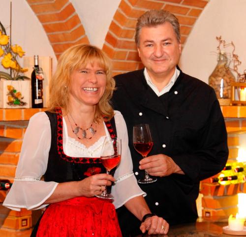 a man and a woman holding glasses of wine at Weststeirischer Hof in Bad Gams