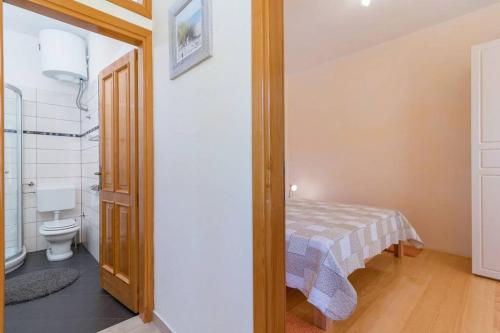 a bathroom with a bed and a toilet in a room at Apartment Lino in Premantura
