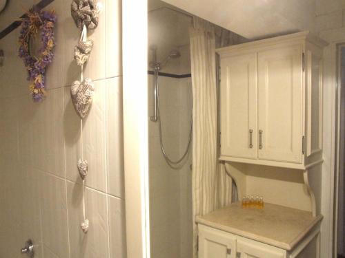 a bathroom with a shower and a toilet and a cabinet at Pisa Stay close to Leaning Tower in Pisa