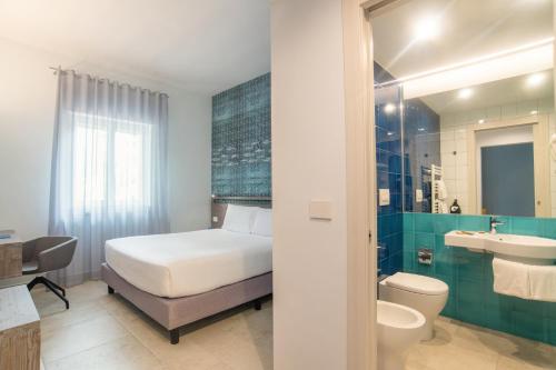 a hotel room with a toilet, sink, and bathtub at Hotel Riva Del Sole in Giovinazzo