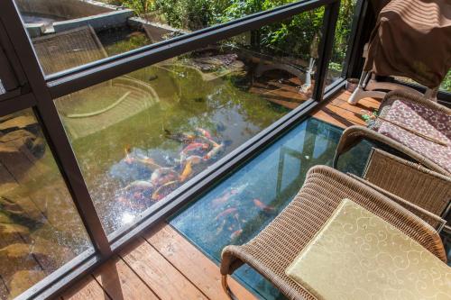 a balcony with a swimming pool and a table and chairs at PULI GuanPu Fallsview Stay House in Puli