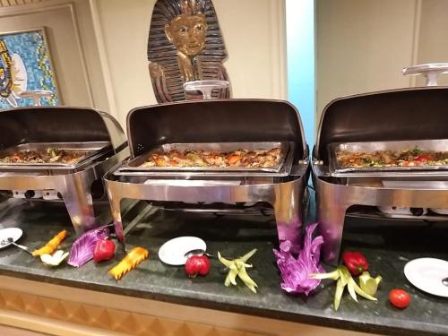 two trays of food on a counter with vegetables at King Tut I Nile Cruise - Every Monday 4 Nights from Luxor - Every Friday 7 Nights from Aswan in Luxor