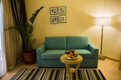 a living room with a couch and a table with a bowl of fruit at Tolip Taba Resort And Spa in Taba