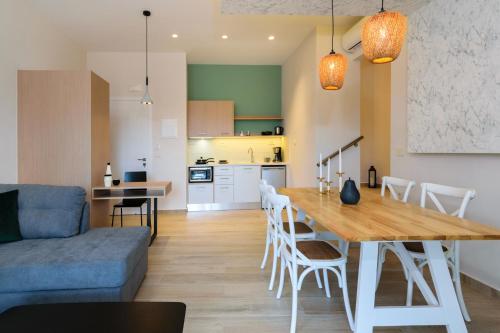 a living room and kitchen with a table and a couch at Iliana Apartments in Falasarna