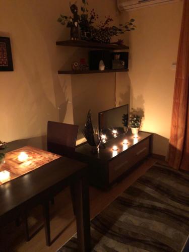a living room with a table with candles on it at Studio Mišel in Vrnjačka Banja